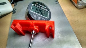 Digital meter installed in a red PLA jig