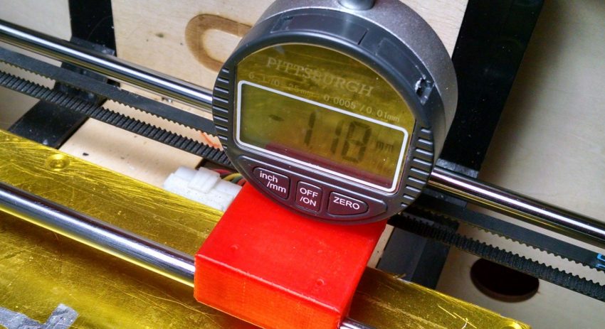 Digital gauge sitting on a 3D printed Jig for leveling the bed of a 3D printer